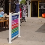 Here is a do it yourself project. This was one of two signs needed to direct people back to the small shops. Positioned close to the line of pedestrian traffic it was hard to miss these signs and indeed business increased substantially to the back row of booths. The sign frames, looked very resortish and they were off the shelf deckrail kits from Lowes. No tools other than a power screwdriver were needed.